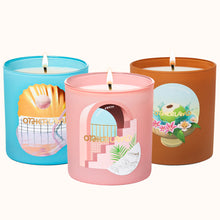 Three candles with colorful lids featuring artistic designs on a white background
