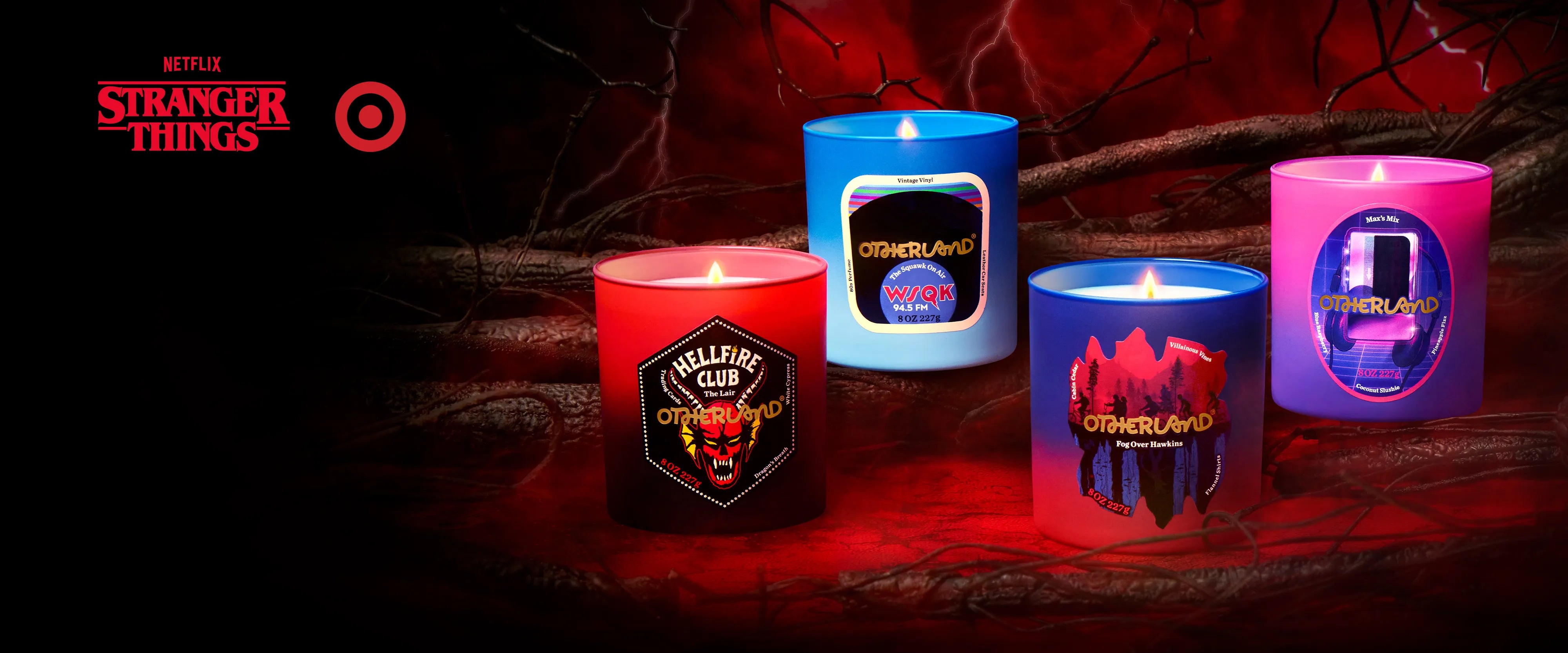 Four candles with 'Stranger Things' branding on a dark background