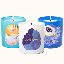 Three candles with 'Otherland' branding on a white background
