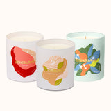 Three candles with colorful labels on a white background