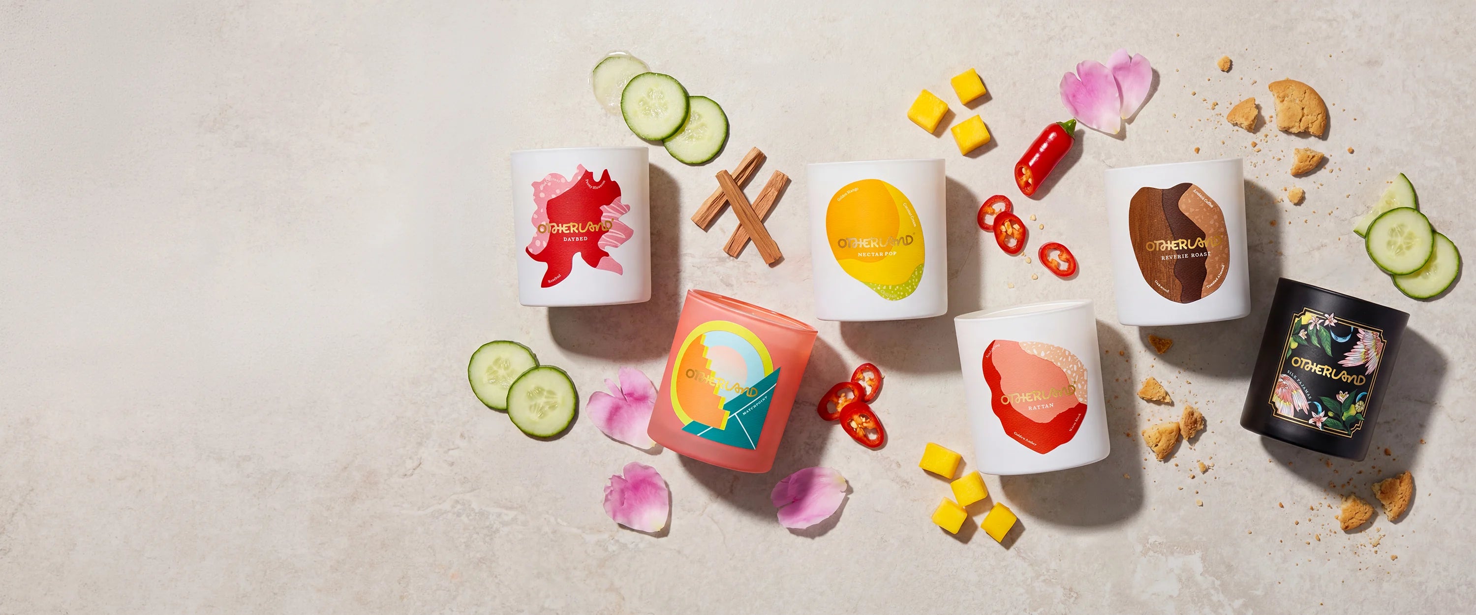 Assorted candles with colorful labels on a light background