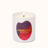 Candle in a white container with a colorful label on a white background