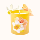 Yellow candle with floral design on a white background