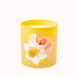 Yellow candle with floral design on a white background