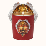 Red candle with decorative label and 'Otherland' branding on a white background