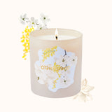 Candle with floral design and 'Otherworld' branding on a white background