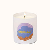 Candle with 'Otherland' branding on a white background
