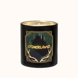 Black candle with gold and green design on a white background
