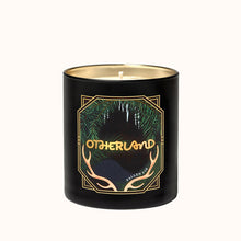 Black candle with gold and green design on a white background