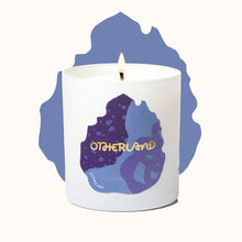 Candle with 'Otherland' branding on a white background
