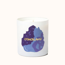 White candle with purple and blue design and 'Otherland' branding on a white background