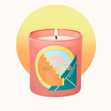 Candle in a pink container with colorful design and 'Otherland' branding on a white background.