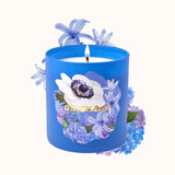 Blue candle with floral design and 'Otherland' branding on a white background