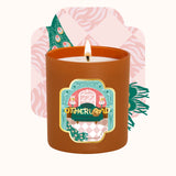 Candle in a decorative container with a colorful label on a white background