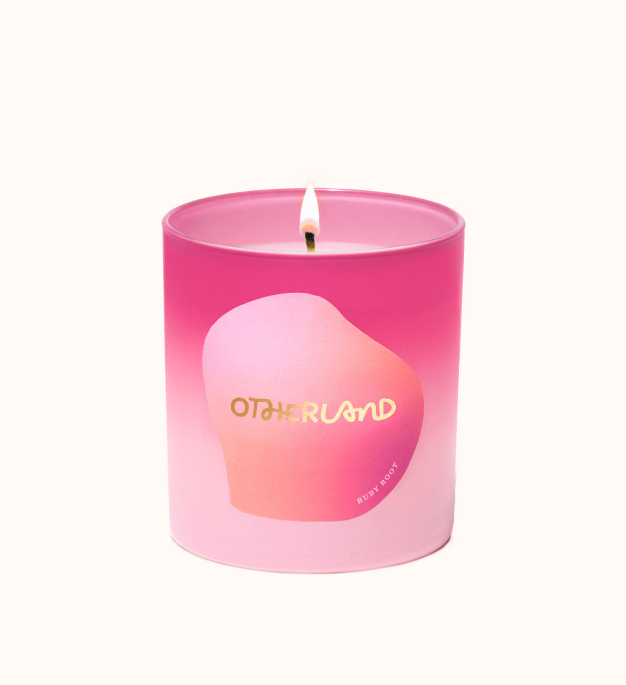 Pink candle with a gradient design and 'Otherland' branding on a white background - View 2