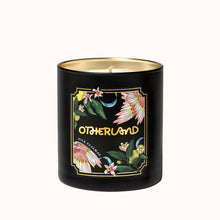 Black candle with floral design and 'Otherland' branding on a white background