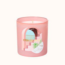 Pink candle with a decorative label on a white background