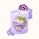 Purple candle with floral design and 'Otherland' branding on a white background