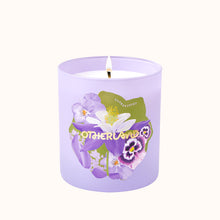 Purple candle with floral design and 'Otherland' branding on a white background