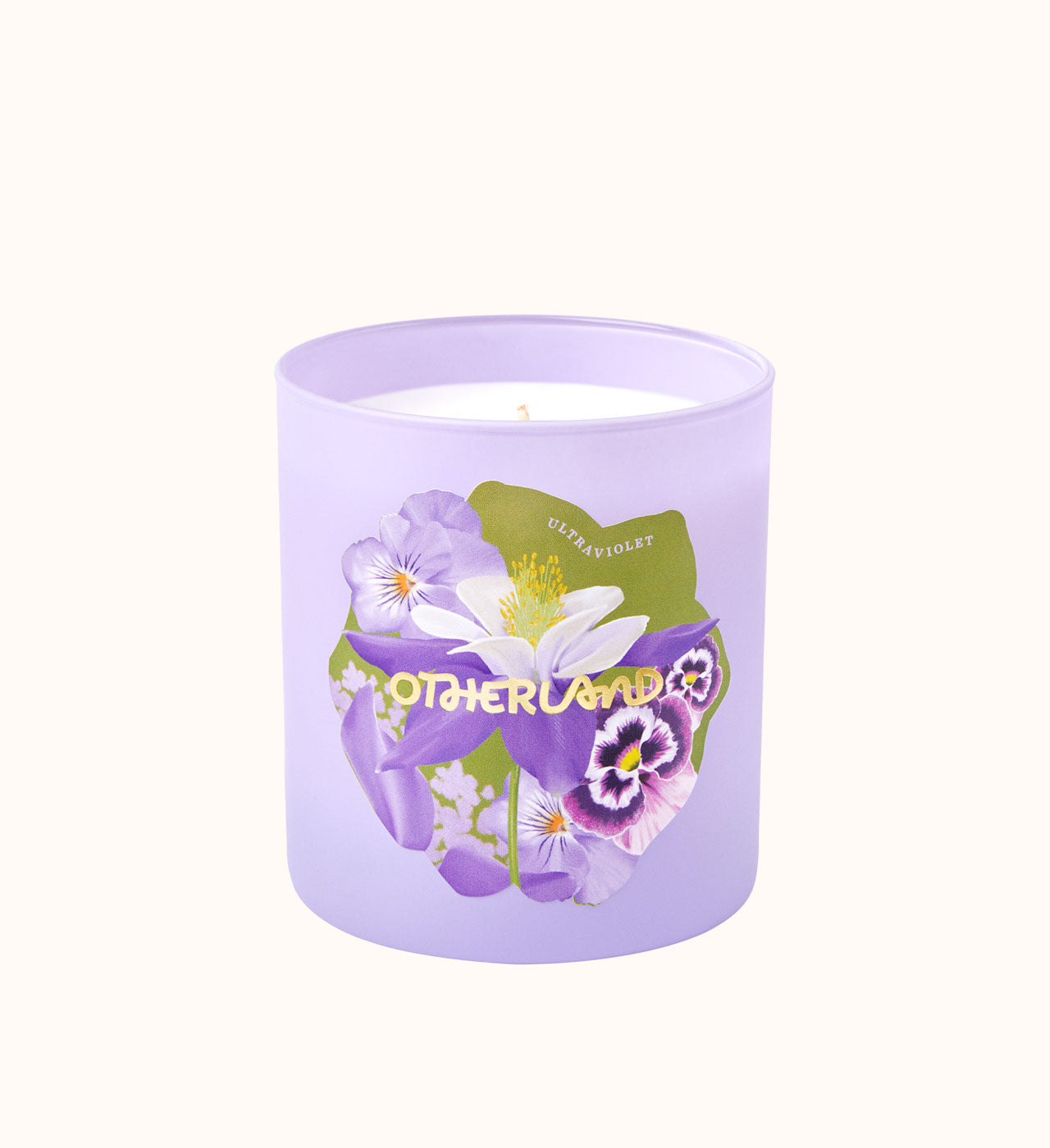 Lavender candle with floral design and 'Otherland' branding on a white background - View 3