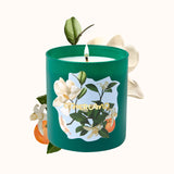 Green candle with floral design and 'Otherland' branding on a white background