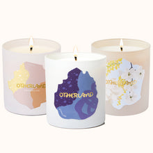Three candles with 'Otherland' branding on a white background