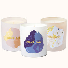 Three candles with 'Otherland' branding on a white background