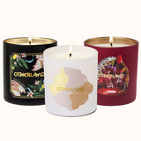 Three scented candles with 'Otherland' branding on a white background