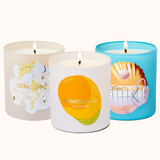 Three candles with different designs on their containers against a white background