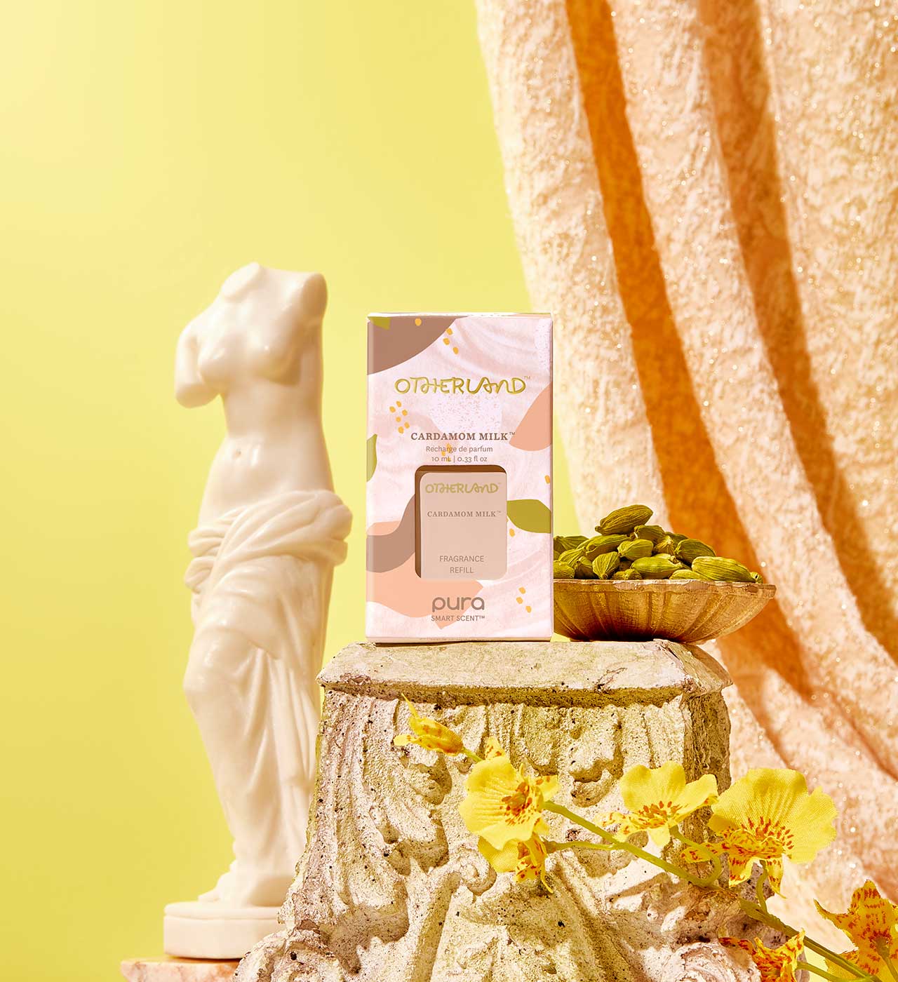 Pura refill product on a decorative stone pedestal with flowers and a statue against a yellow background - View 2