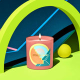 Candle with a colorful label on a vibrant background
