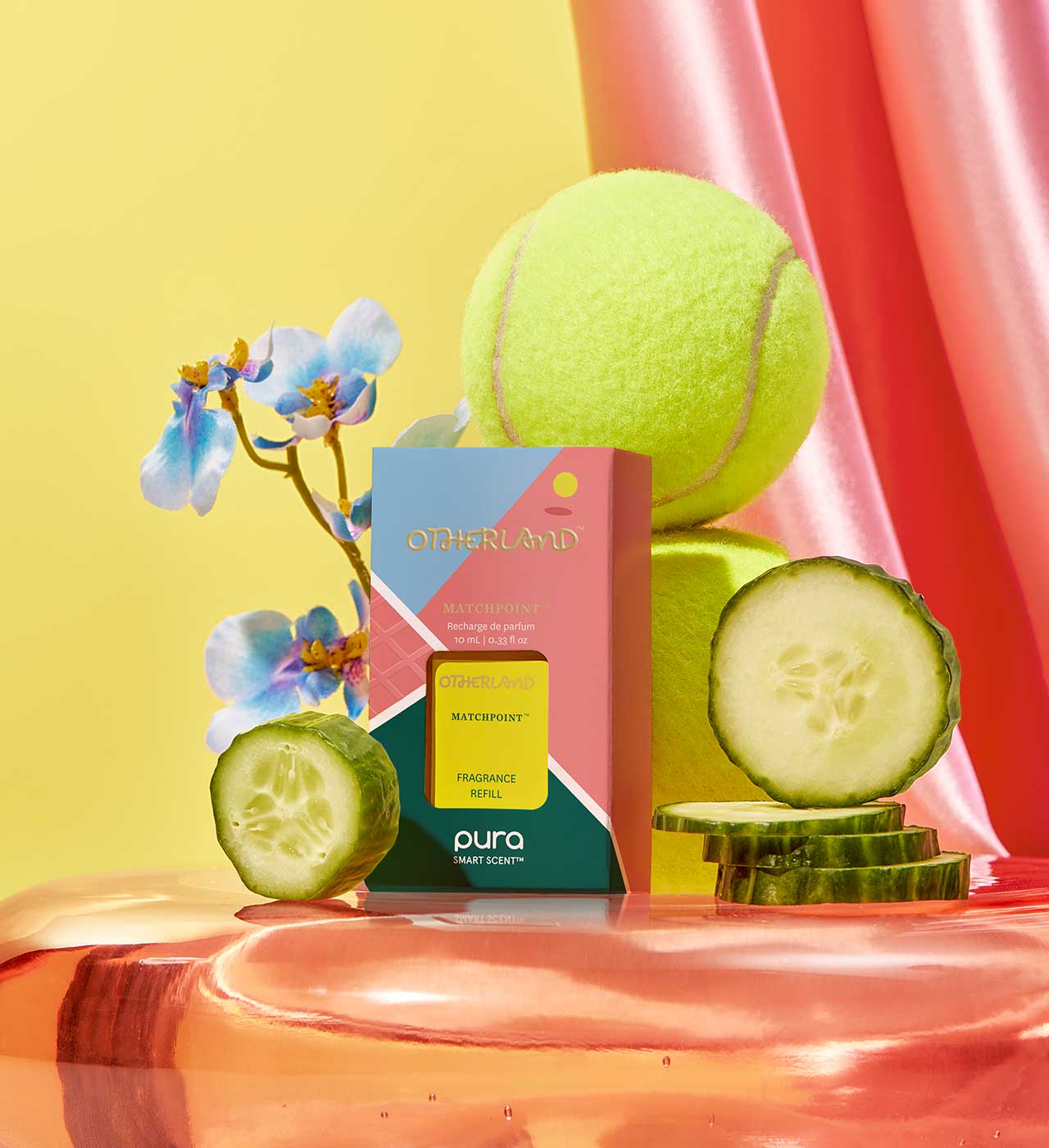 Pura refill product with a tennis ball, cucumber slices, and flowers on a colorful background - View 2