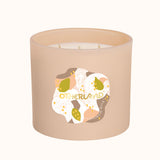Beige candle with a decorative label on a white background