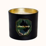 Black candle with gold interior and 'Otherland' logo on a white background
