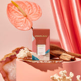 Otherland perfume bottle with pink anthurium flower and coral background