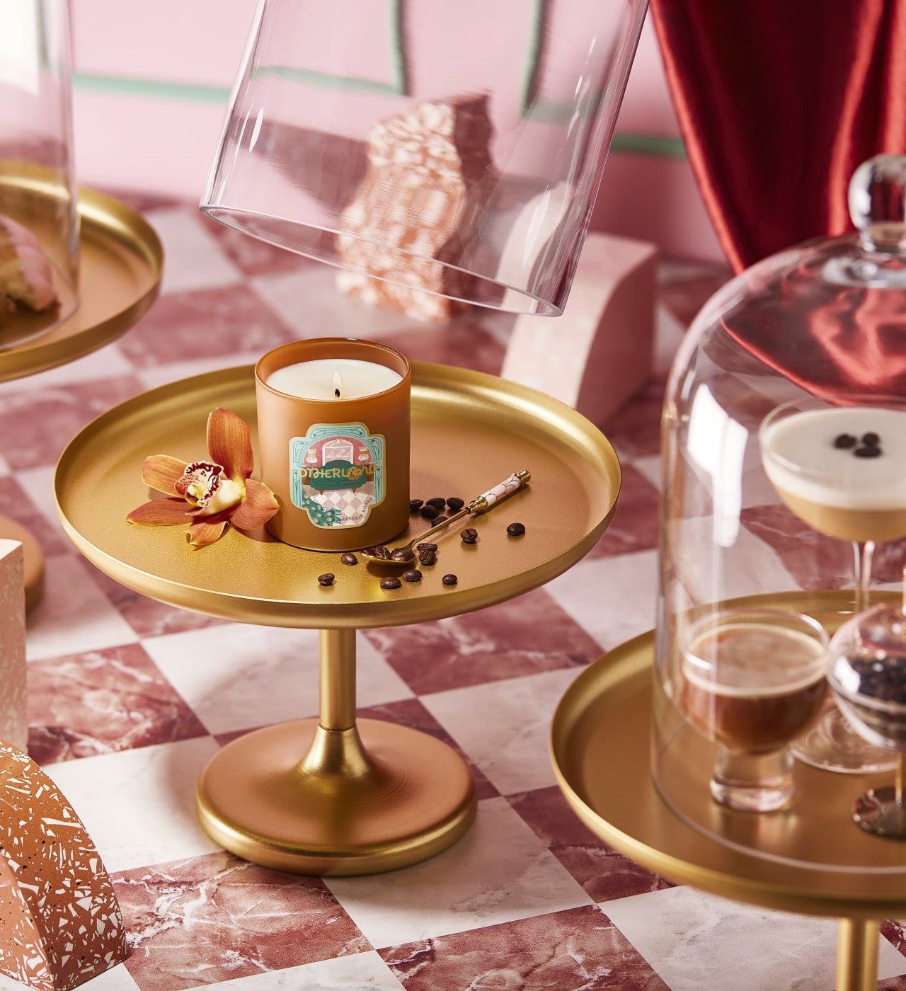 Candle on a gold tray with decorative elements on a checkered tablecloth - View 2