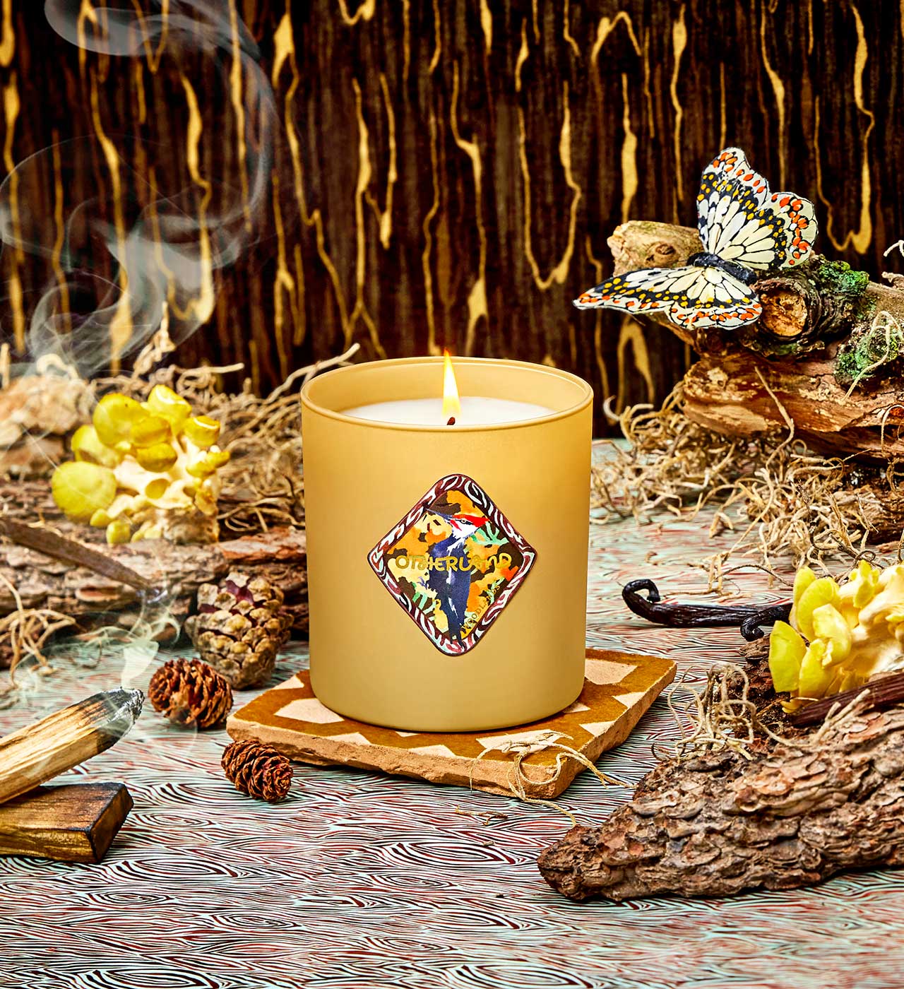 Candle with decorative label on a wooden surface with natural elements - View 2
